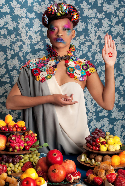 The Persephone cape is wearable art with crocheted skulls & hand beaded crochet flowers. Dramatically flattering the head with a ruff constructed of beaded flowers, a figure flattering  décolleté & waist hemline.